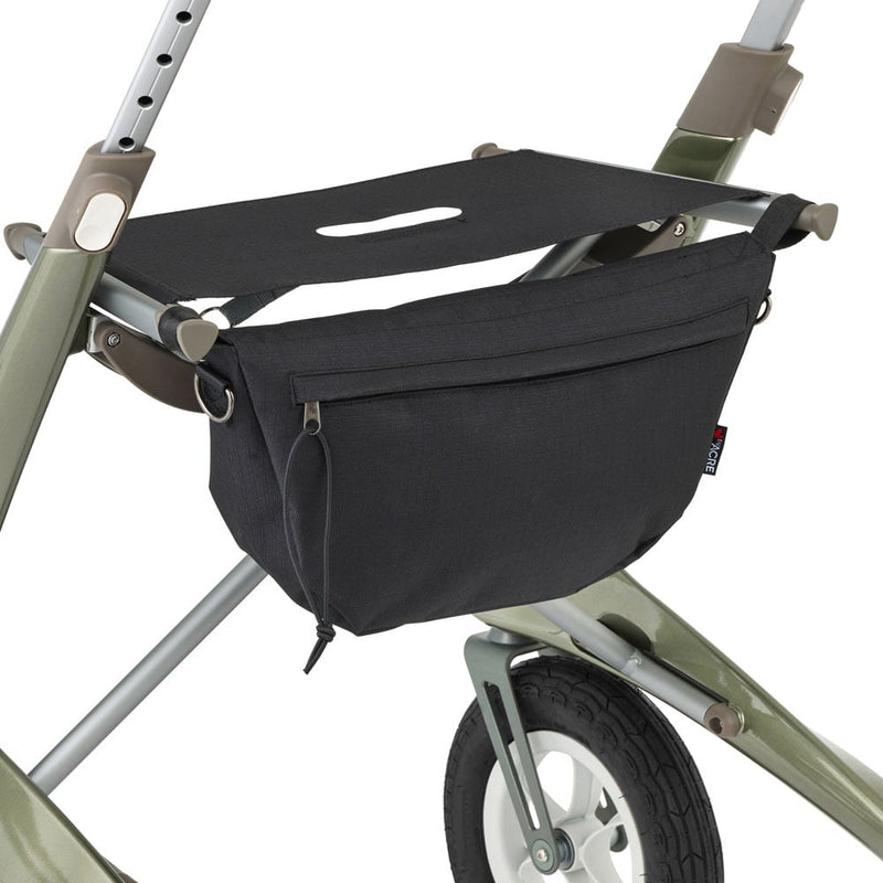 A black fabric bag with a drawstring and zipper, mounted on the frame of a green and silver walker against a white background.