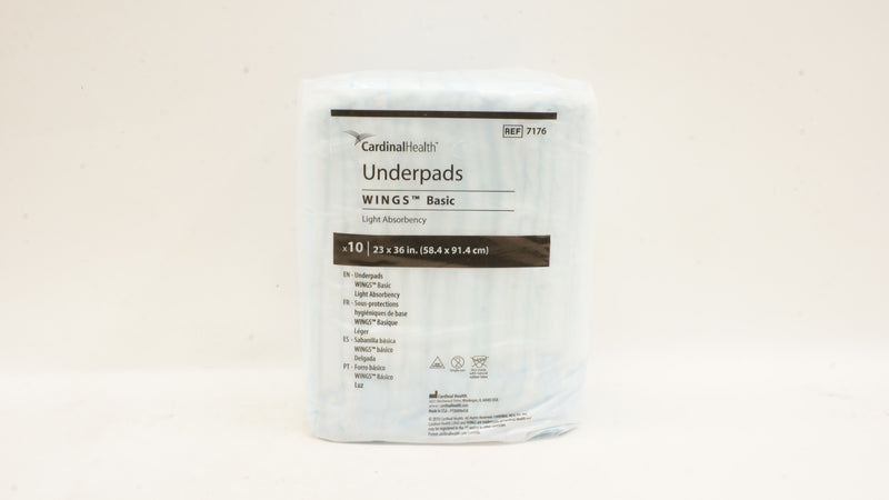 Package of Cardinal Health underpads on a beige background