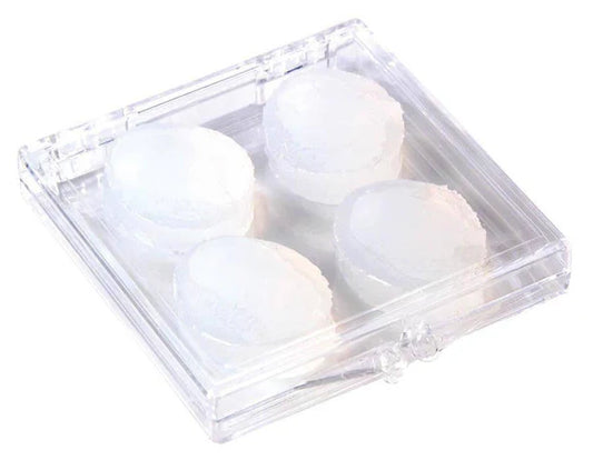 Clear plastic container with four white ear plugs on a white background
