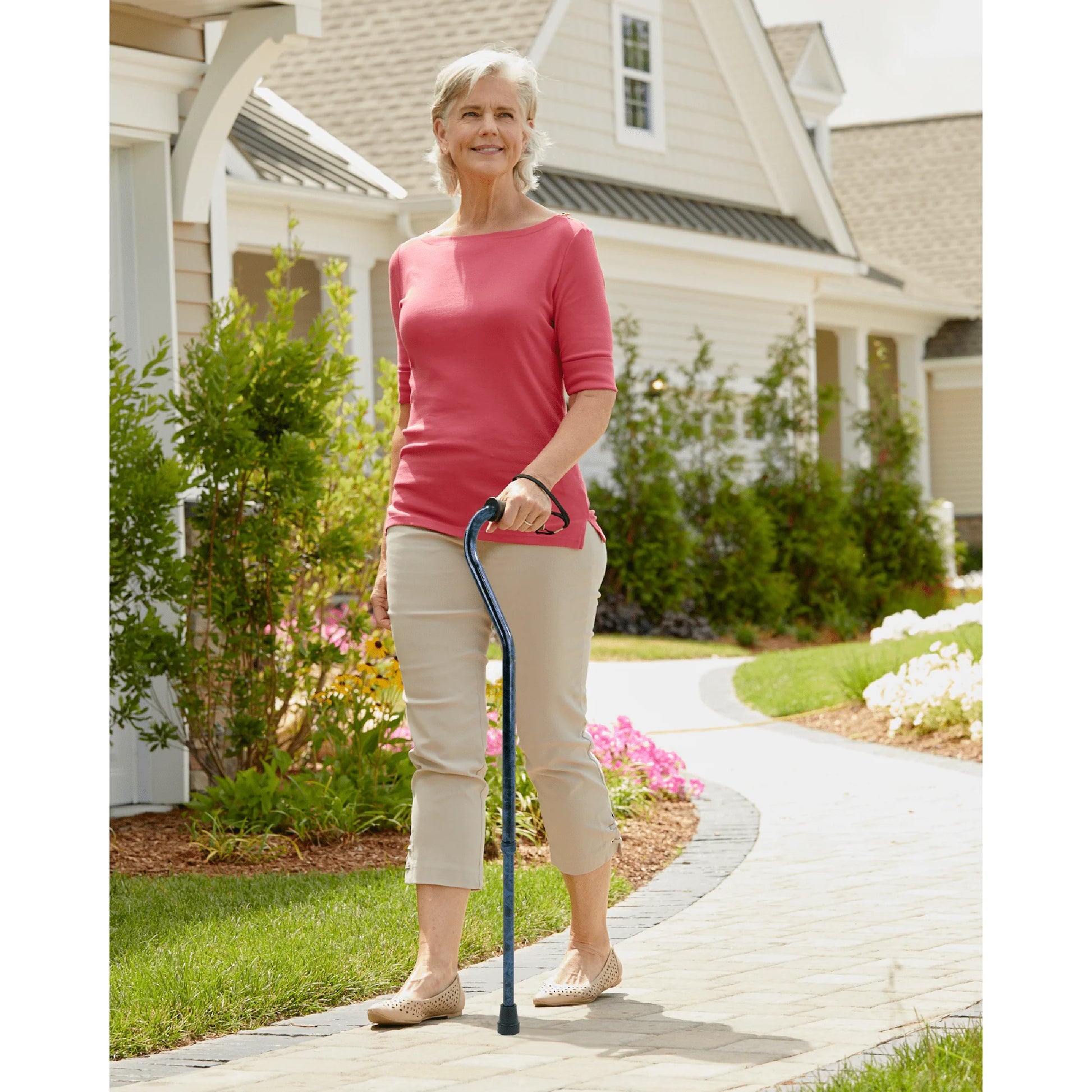 Woman walking with a cane in a residential area