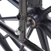 Close-up of a bicycle wheel hub with bearings and spokes on a white background