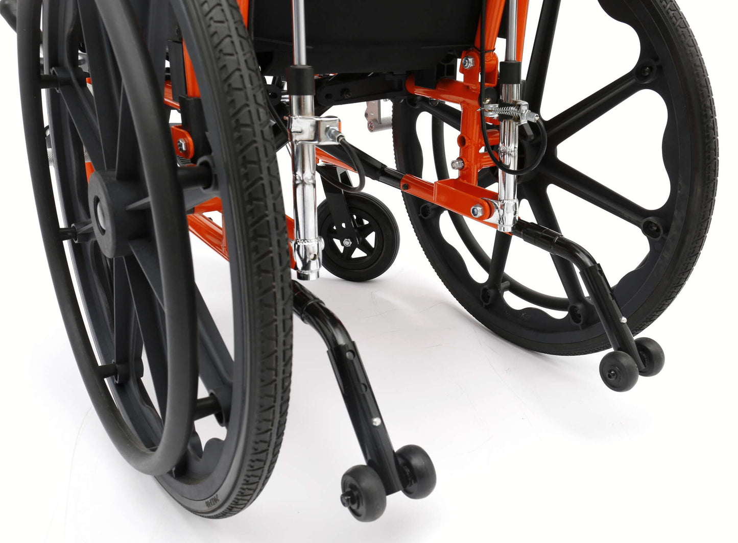 Close-up of a wheelchair with black wheels and orange frame on a white background