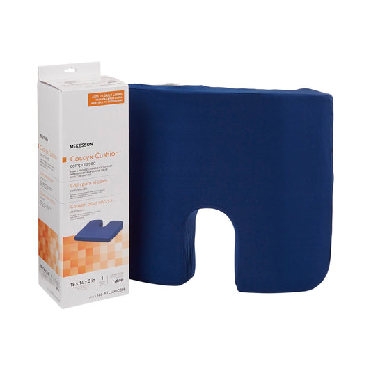Blue coccyx cushion next to its packaging on a white background