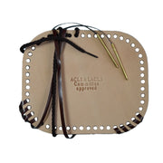 Beige leather case with holes, black and brown strings, and gold pen on a white background