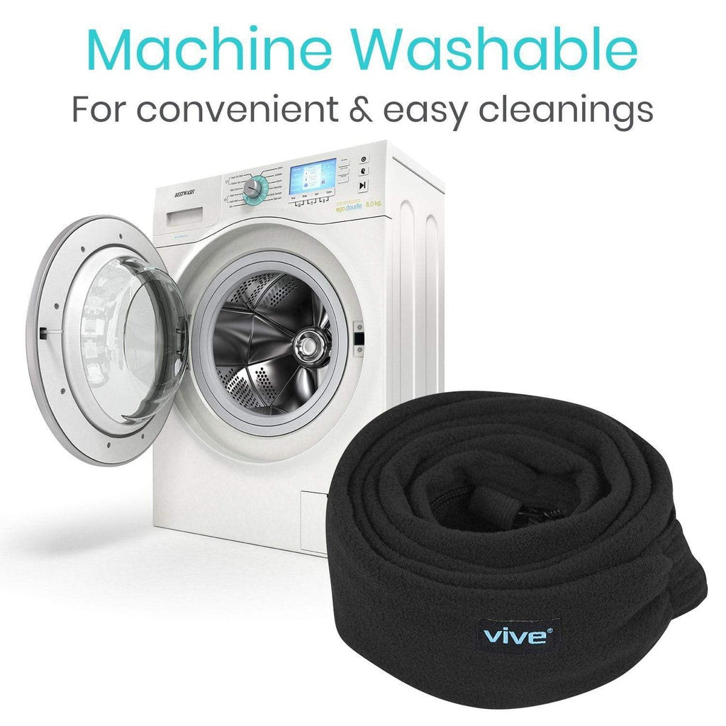 Black neck wrap with 'Vive' branding next to a white washing machine with open door.