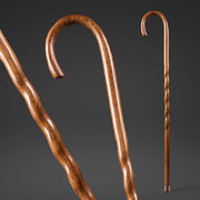 Two wooden walking canes on a dark background