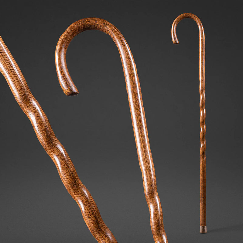 Two wooden walking canes on a dark background