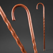 Two wooden walking canes on a dark background