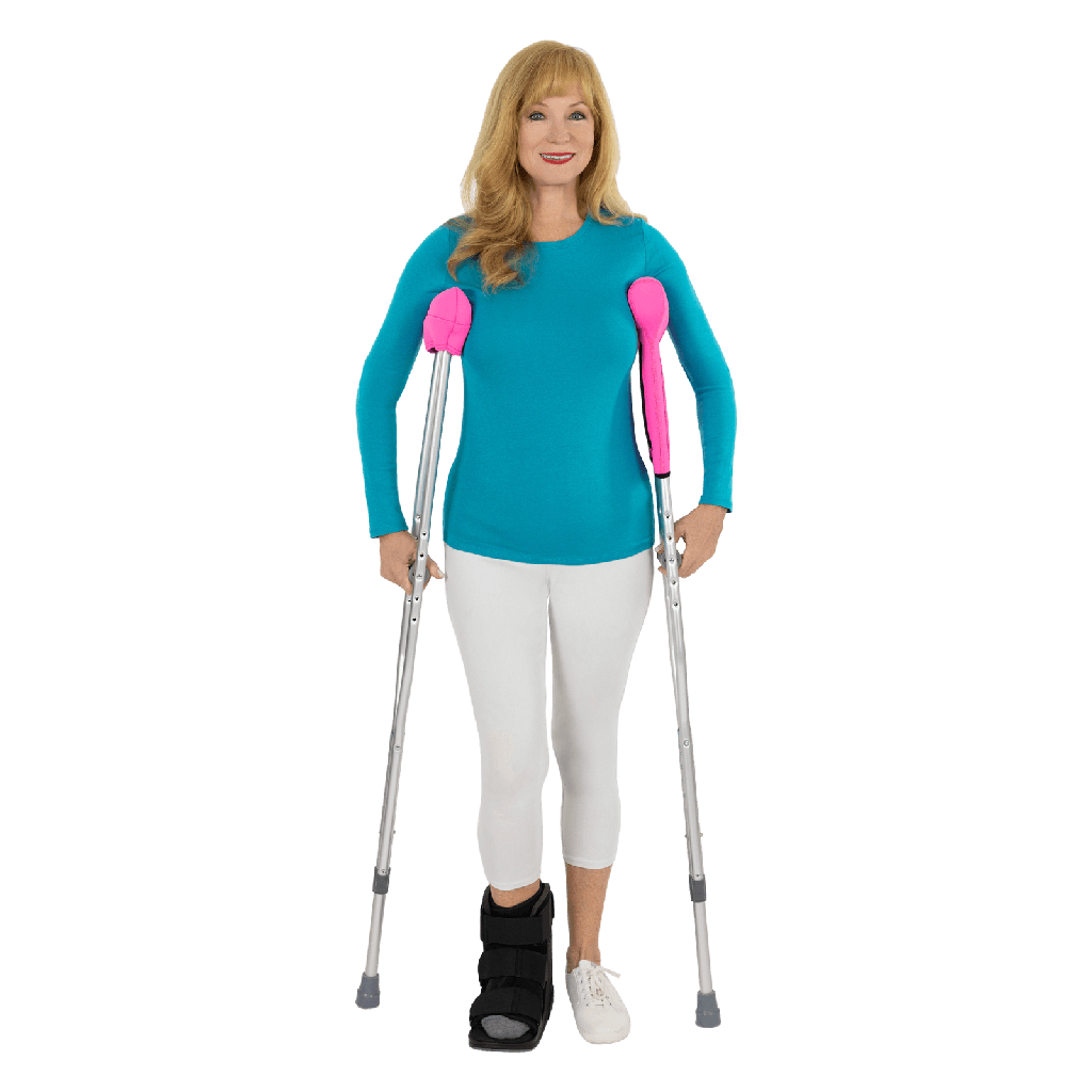 woman wearing orthotic boot and using crutches
