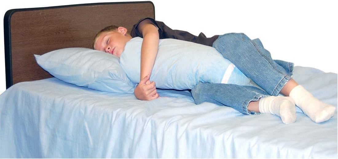 Person lying on a bed with a large pillow