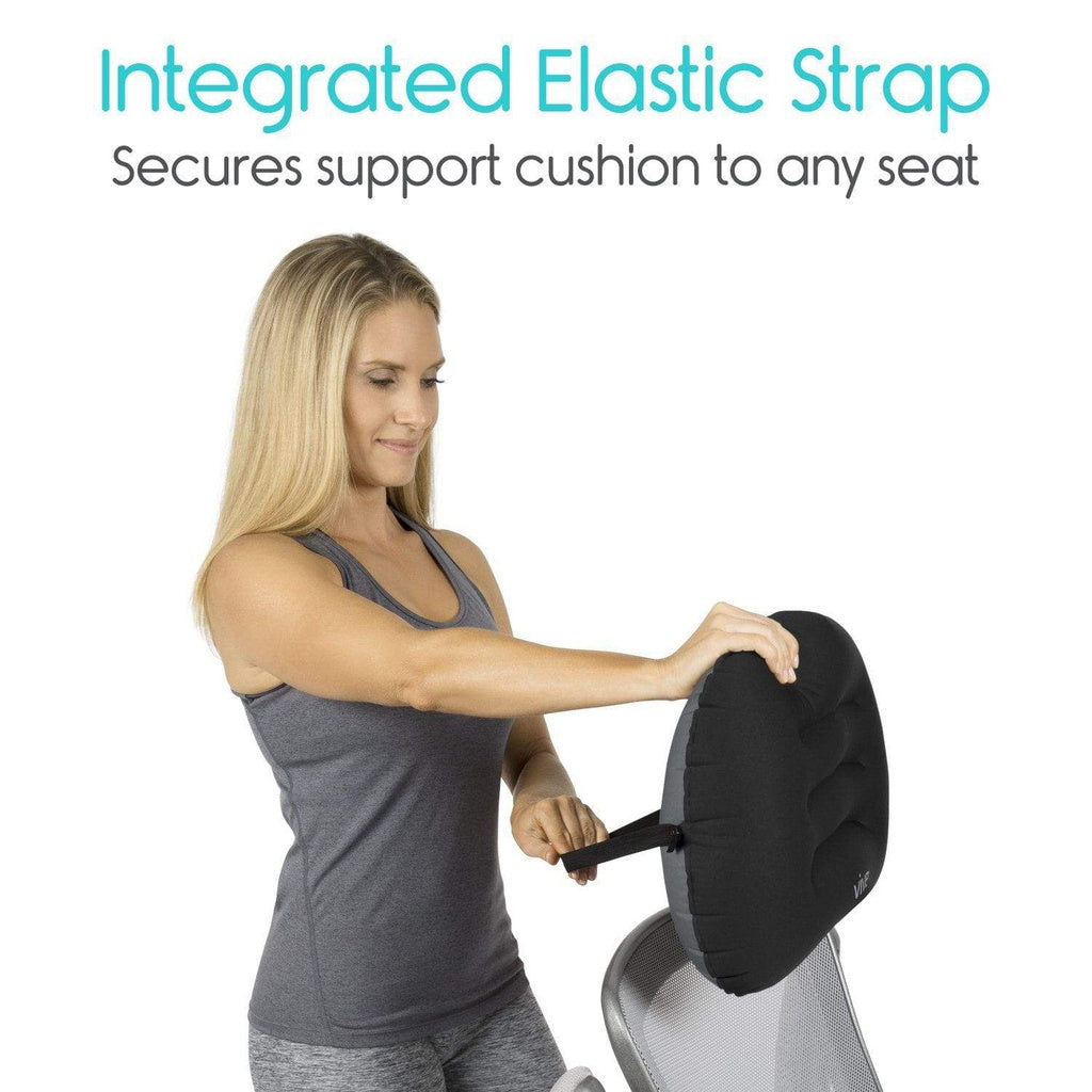 Woman using a black support cushion with an integrated elastic strap on a white background