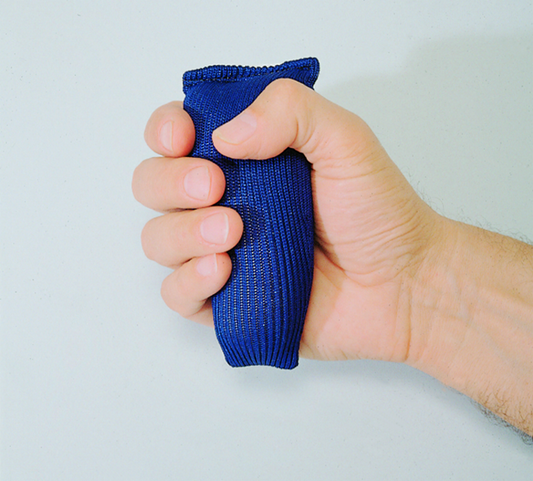 Hand holding a blue fist-shaped object against a light gray background