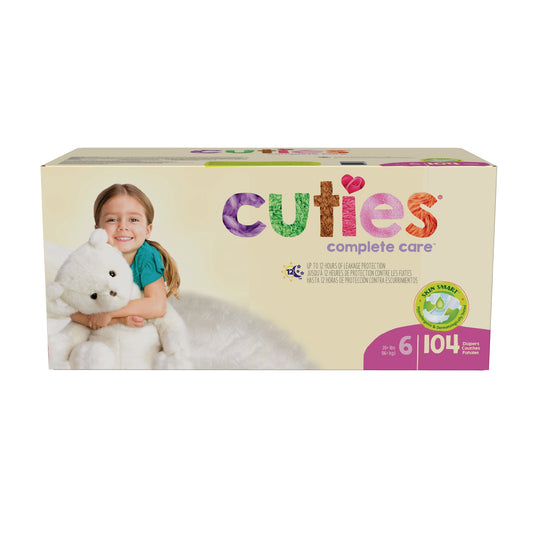 Box of Cuties complete care diapers with a child holding a teddy bear on a white background