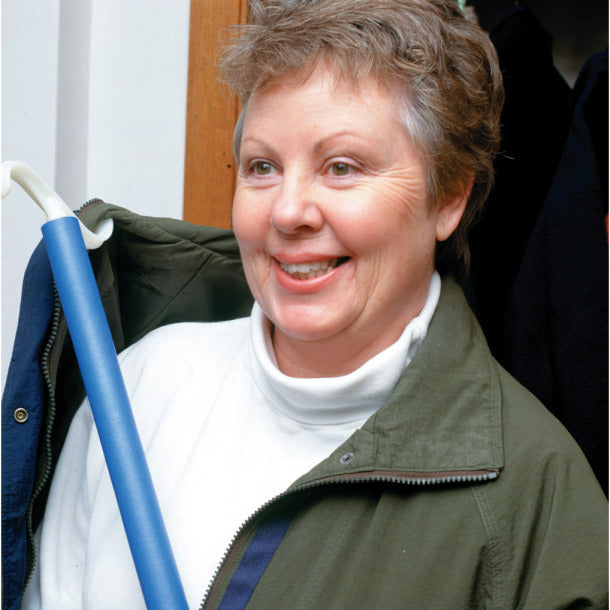 Woman wearing a green jacket and white shirt, holding a blue pole.