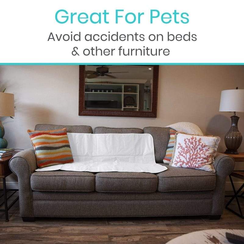 Gray sofa with a white cover on it, surrounded by decorative pillows, in a living room setting.