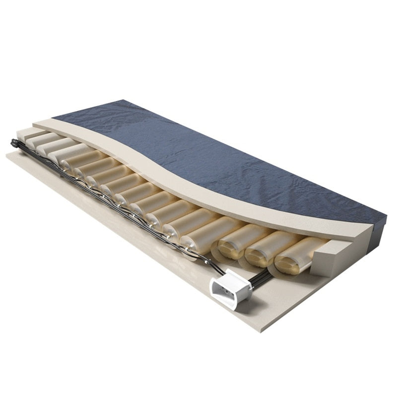 An isometric 3D rendering of a mattress topper or cushion insert, showing a dark blue textured top layer, a beige contoured support base, and multiple cylindrical foam or gel rolls.