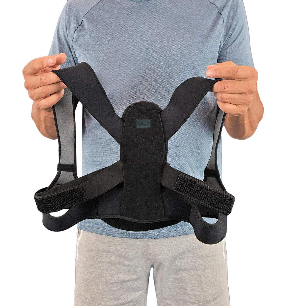 Person holding a black back brace against a white background