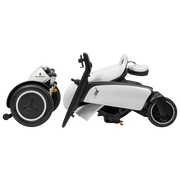 A white and black power wheelchair shown in a side profile view on a solid white background, with its rear wheels folded forward. The brand name 'Palmersa' is visible on the wheel hub.
