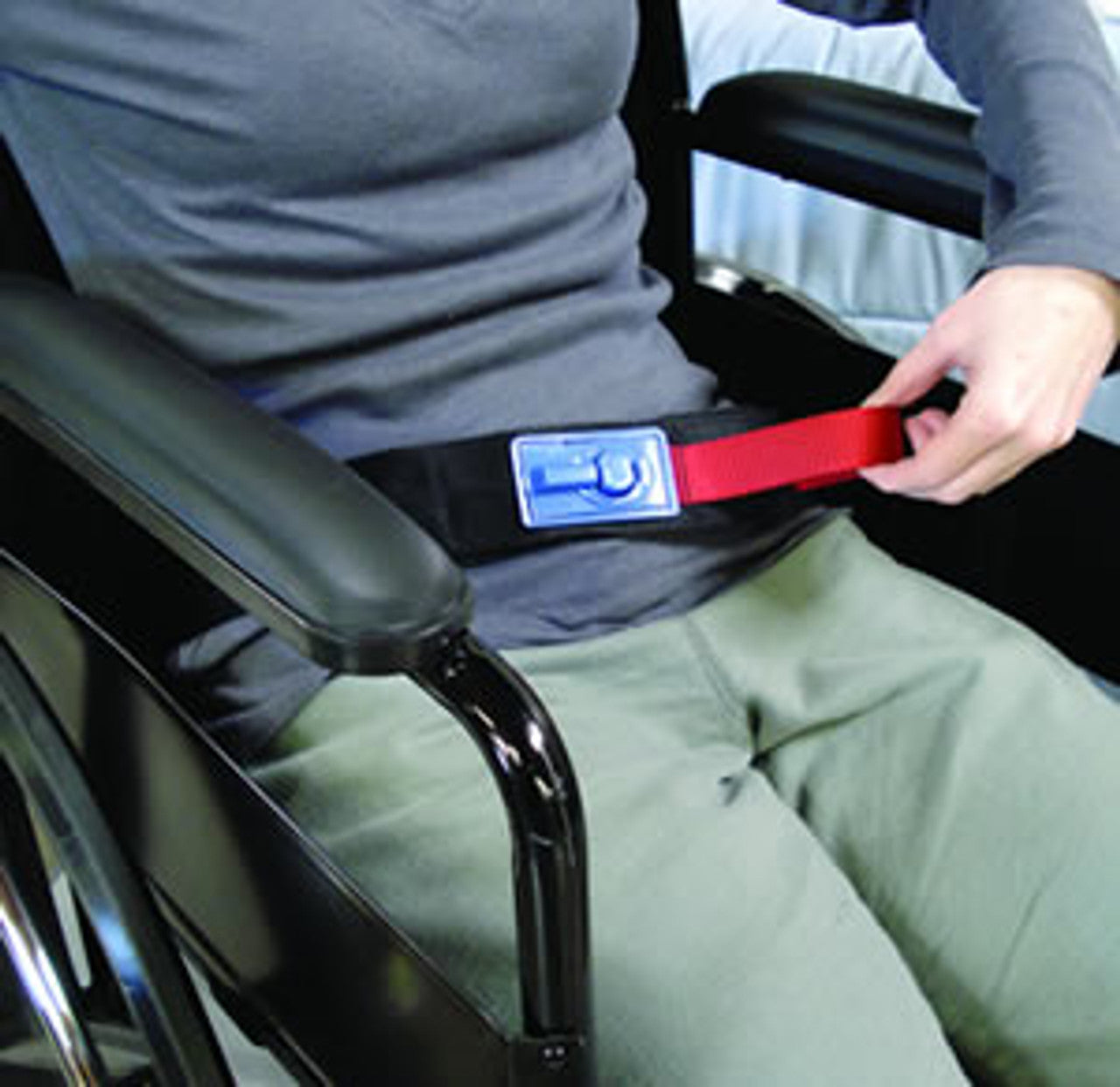 Person in a wheelchair using a safety belt with a visible brand label.