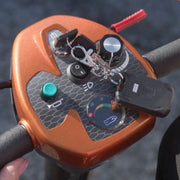 Close-up of a control panel with buttons and levers against a blurred background
