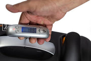Hand holding a digital luggage scale displaying weight, with a white background