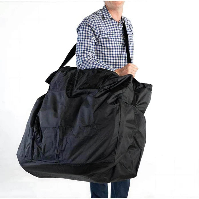 Person holding a large black duffel bag on a white background