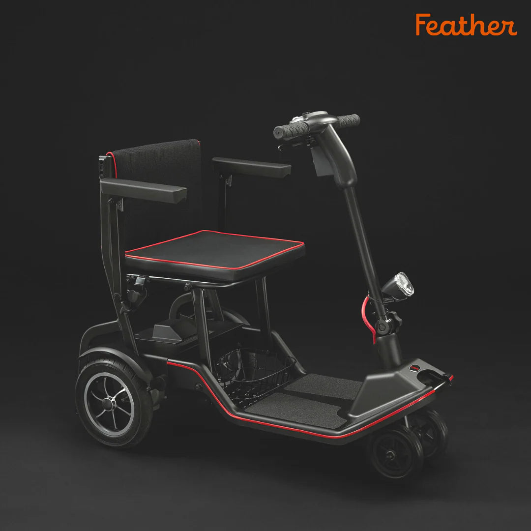 Black mobility scooter with a seat and red accents on a dark background, branded 'Feather'.