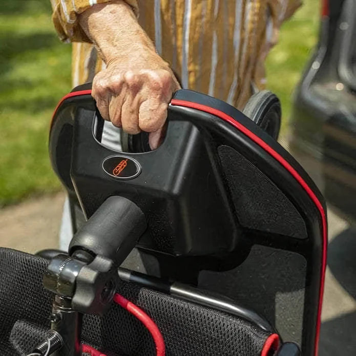Close-up of a hand gripping a golf club's grip, with a blurred background.