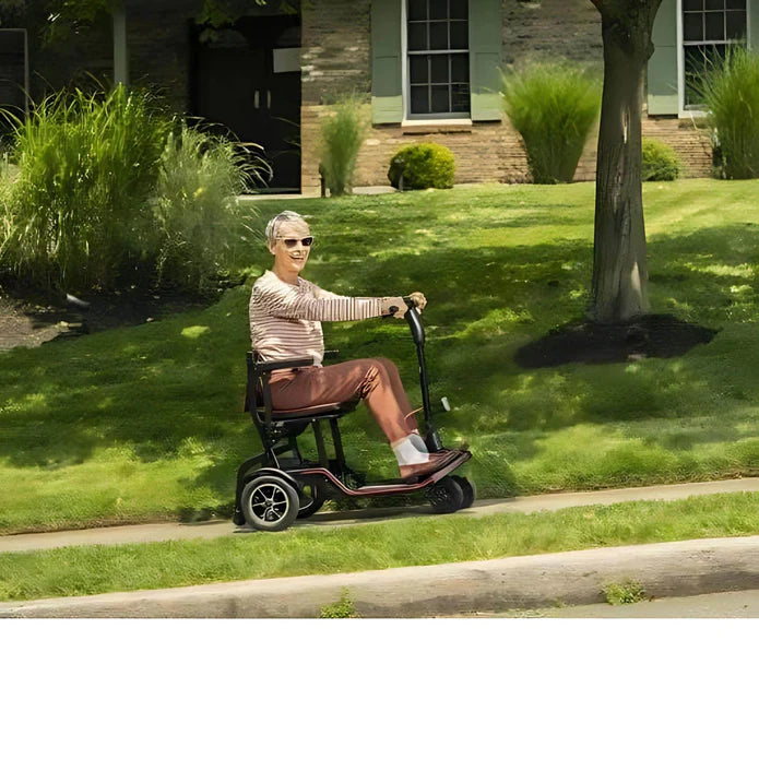 Man riding a mobility scooter on a grassy area with a house in the background