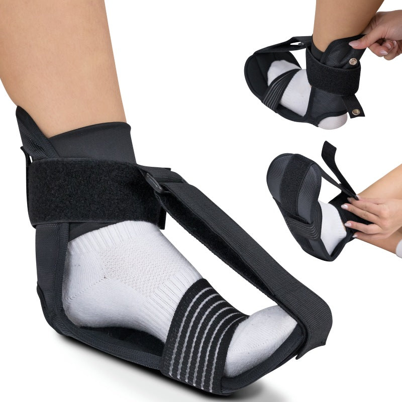 Black ankle support brace being worn on a foot with a white sock, held by a hand.