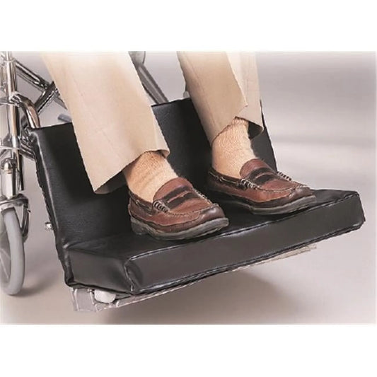 Wheelchair with a footrest extension showing a person's feet wearing brown shoes.
