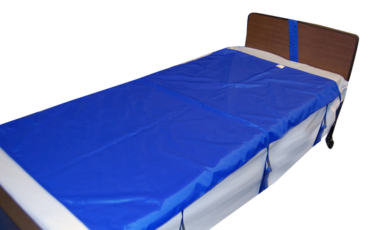 Blue mattress cover on a bed with wooden headboard
