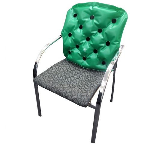 Green cushion with black dots on a chair against a white background