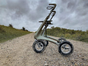 Rollator on a gravel path with grass and trees in the background
