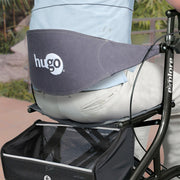 Baby seat with 'hugo' branding attached to a stroller.