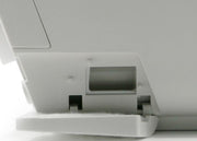 Close-up of a printer with paper tray on a white background