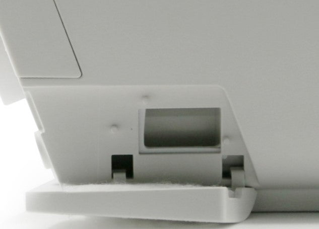 Close-up of a printer with paper tray on a white background