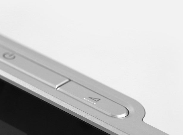 Close-up of a metallic phone case with buttons on a white background