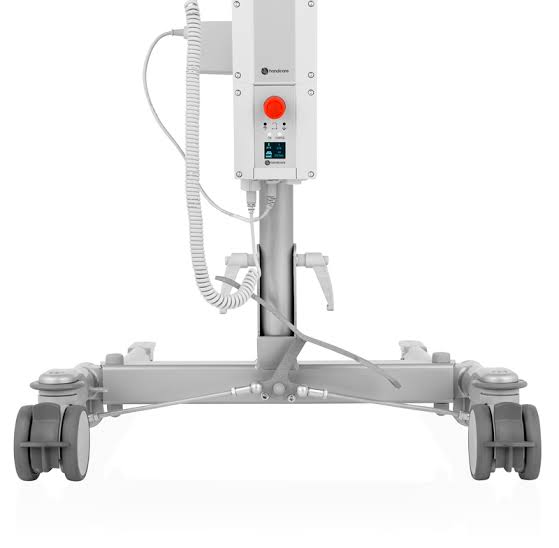 A medical lift unit with a white control console, red emergency stop button, coiled cable, and a gray wheeled base on a white background.