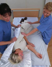 caregivers using a transfer sheet
