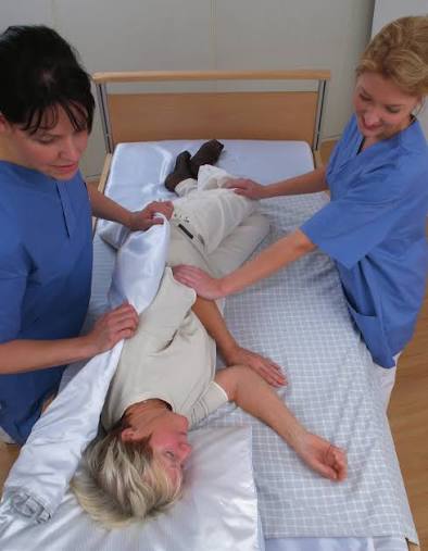 caregivers using a transfer sheet