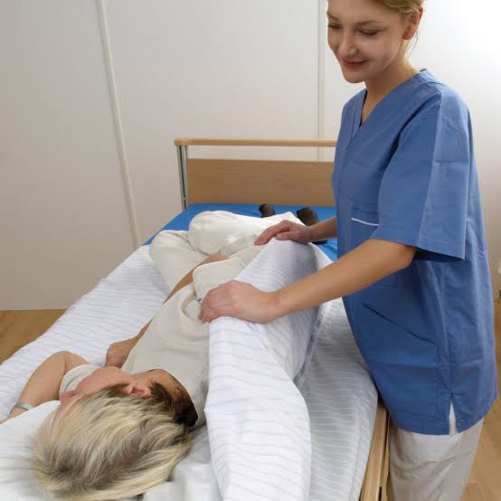 caregivers using a transfer sheet