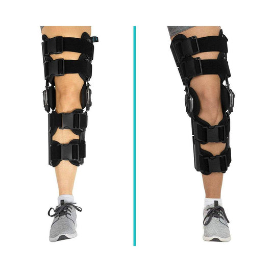 Black knee brace on a person's leg with a white background