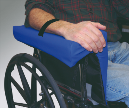 Person using a wheelchair with a blue armrest cover on a gray background