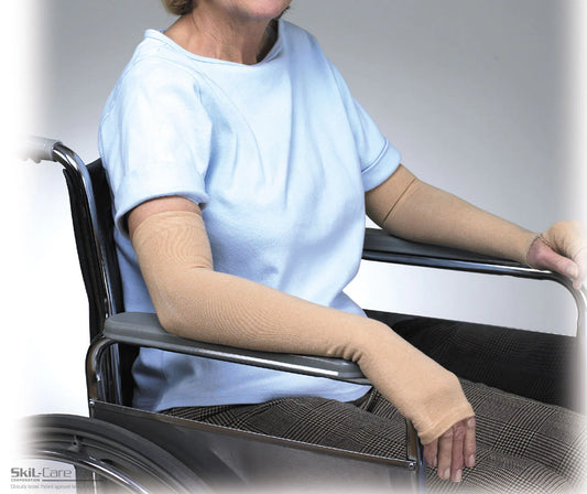 Person in a wheelchair wearing a compression sleeve on one arm, with 'Skill-Care' branding visible.