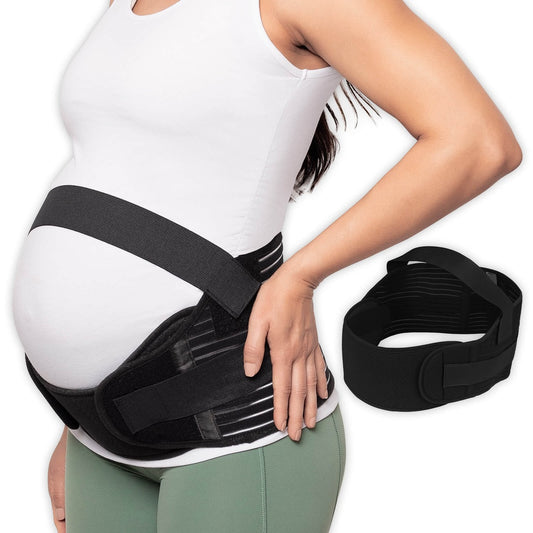 Pregnant woman wearing a black maternity belt with a plain background