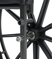 Close-up of a wheelchair wheel with metal hub and spokes on a white background