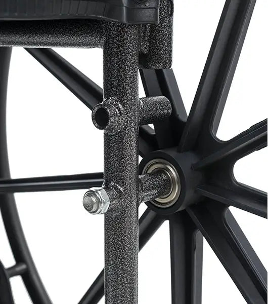 Close-up of a wheelchair wheel with metal hub and spokes on a white background