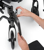 Person adjusting a wheelchair's armrest on a white background