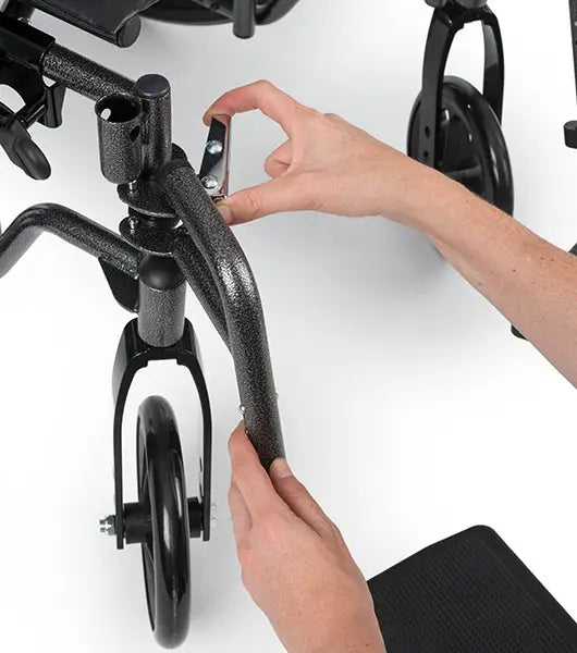 Person adjusting a wheelchair's armrest on a white background